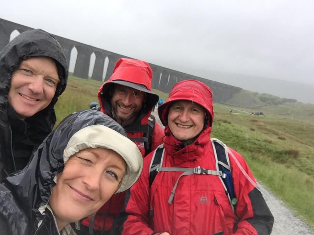 Members of the Spencer Group More Together team reach Ribblehead Viaduct during the Yorkshire Three Peaks challenge.